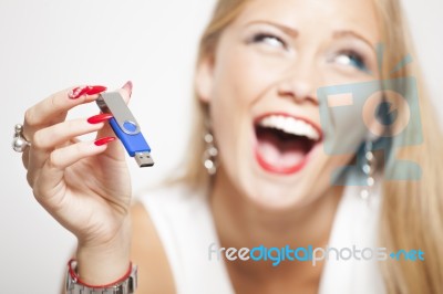 Smiling Woman With Usb Memory In Hands Stock Photo