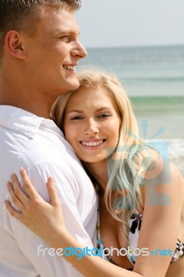 Smiling Young Couple At Beach Stock Photo