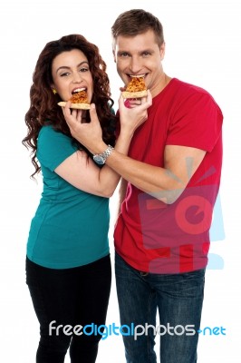Smiling Young Couple Sharing Pizza Stock Photo
