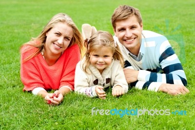 Smiling Young Family In Outdoors Stock Photo