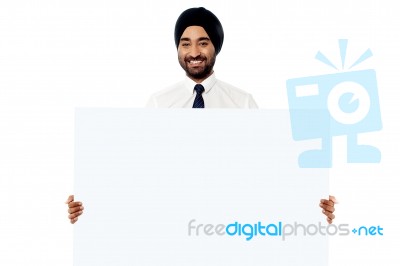 Smiling Young Man Holding White Sign Board Stock Photo