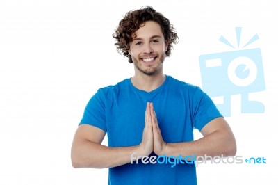 Smiling Young Man In Welcome Gesture Stock Photo