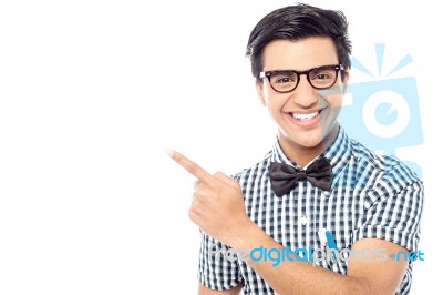 Smiling Young  Man Pointing Away Stock Photo