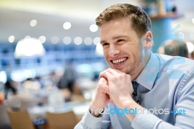 Smiling Young Man Relaxing In A Cafe Stock Photo