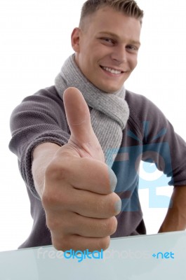 Smiling Young Man Showing Thumb Up Stock Photo