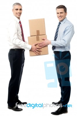 Smiling Young Men Receive Cartons Boxes Stock Photo