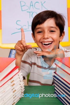 Smiling Young Student Pointing Up Stock Photo