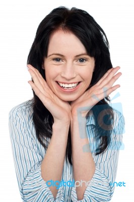 Smiling Young Woman Resting Her Chin Over Palms Stock Photo