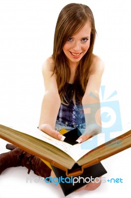 Smiling Young Woman Showing Books Stock Photo