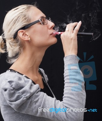 Smoking Electric Cigarettes On The Black Background Stock Photo