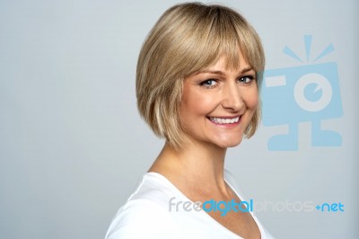 Snap Shot Of A Cheerful Blonde, Side Pose Stock Photo
