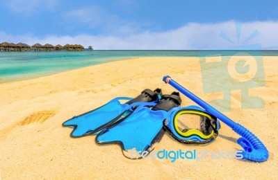 Snorkling Gear On The Beach With Water Bungalows And The Beach In Maldives Stock Photo