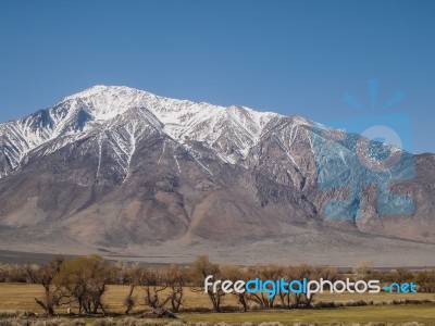 Snow Capped Mountains, Blue Sky, Desert Landscape Stock Photo