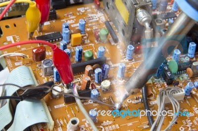 Soldering Iron On Electronic Board Stock Photo