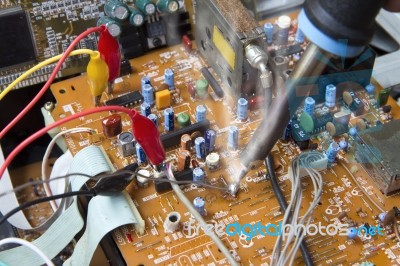Soldering Iron On Electronic Boards Stock Photo