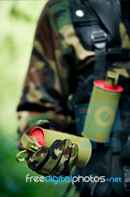 Soldier Carrying A Smoke Bomb Stock Photo