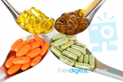 Spoon With Colorful Vitamin Medicine Pills Stock Photo