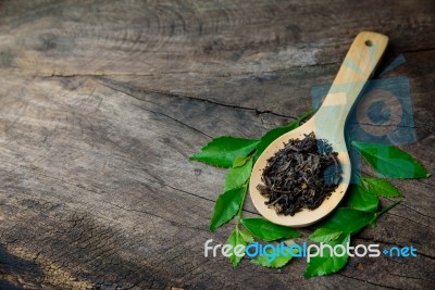 Spoons With Dried Leaves Tea And Green Leaves Tea Stock Photo