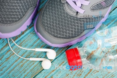 Sport Shoes With Earphones And Drinking Water Stock Photo