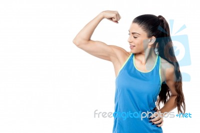 Sporty Woman Flexing Her Biceps Stock Photo