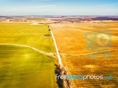 Spring Green And Brown Agricultural Fields. Village On Backgroun… Stock Photo