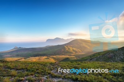 Spring Sunset In The Mountains. Seacoast And Hills Stock Photo