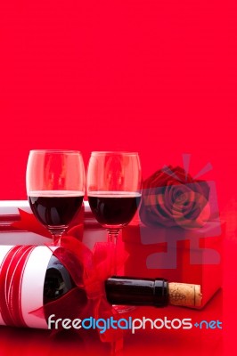 St Valentine's Setting With Present And Red Wine Stock Photo