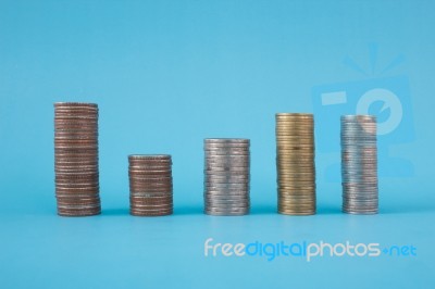 Stack Of Coins On Blue Soft Background Stock Photo Stack Of Coins On Blue Soft Background Stock Photo