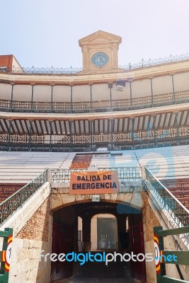 Stands With An Emergency Exit And The Ancient Clock Of A Spanish Arena Stock Photo