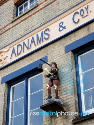 Statue Of A Boy Hitting A Bell Outside Adnam's Brewery In Southw… Stock Photo