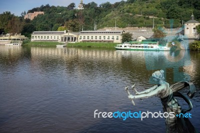 Statue Of A Woman With Torches On The Cechuv Bridge In Prague Stock Photo