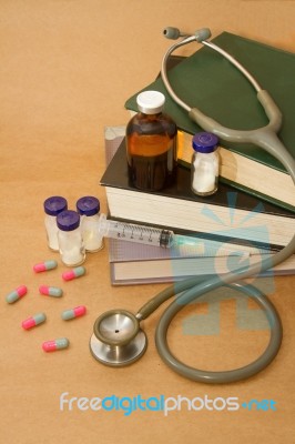 Stethoscope And  Medications On Medical Book Stock Photo