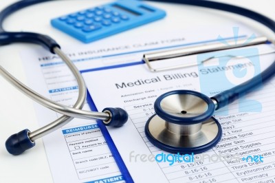 Stethoscope On Medical Bills And Insurance Stock Photo