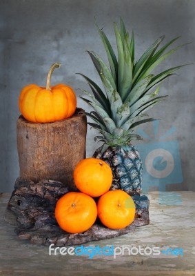 Still Life Pumpkin,pineapple And Tangerine Stock Photo