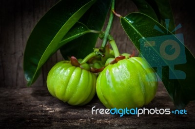 Still Life With Fresh Garcinia Cambogia On Wooden Background Stock Photo