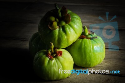 Still Life With Fresh Garcinia Cambogia On Wooden Background Stock Photo