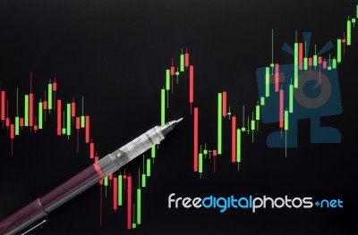Stock Or Forex Graph Or Candlestick Chart And Pen On Black Screen Stock Photo