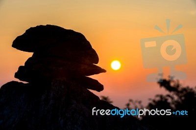 Stone Silhouette Against Sunset Stock Photo