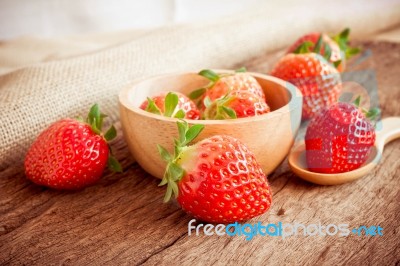 Strawberry In A Bowl On Wooden Background Stock Photo