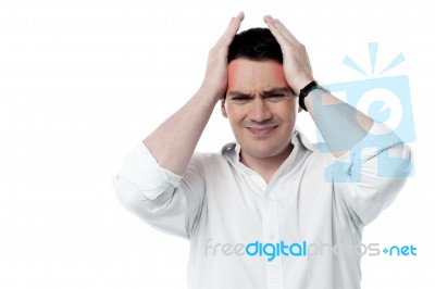 Stressed Man Having Strong Headache Stock Photo