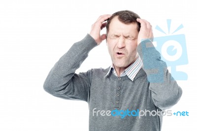 Stressed Man Suffering From Headache Stock Photo