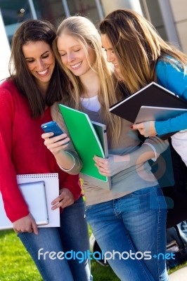 Students Having Fun With Smartphones After Class Stock Photo