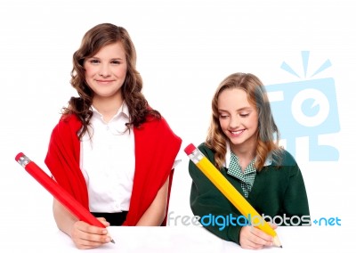 Students Writing With Pencil Stock Photo