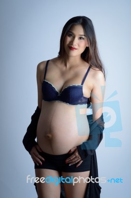 Studio Shot, Portrait Of The Young Smiling Pregnant Long Hair As… Stock Photo