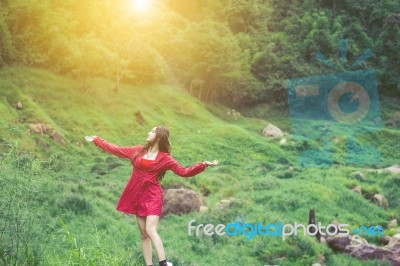 Summer Portrait Of Young  Women Enjoying Nature  In Tight Fitting Red Dress Summer Vacation,sunny,having Fun, Positive Mood,romantic, Against Background Of Summer Green Park, Green Leaves Stay Outdoor Stock Photo