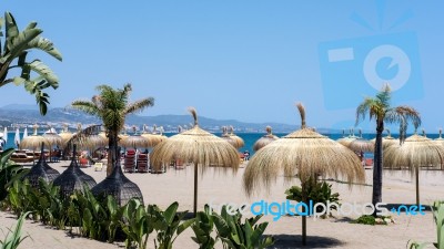 Sun Umbrellas On The Beach At Puerto Banus Stock Photo