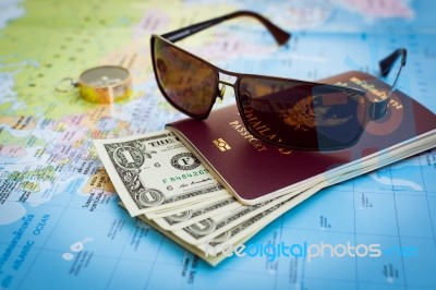 Sunglasses, Passport, Money And Compass On The Map Stock Photo