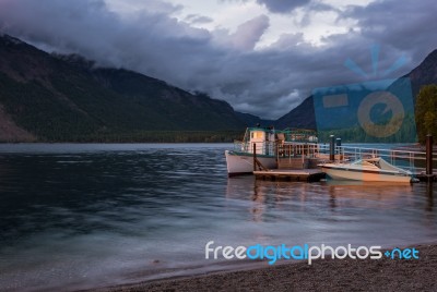Sunlit Boats At Lake Mcdonald Stock Photo