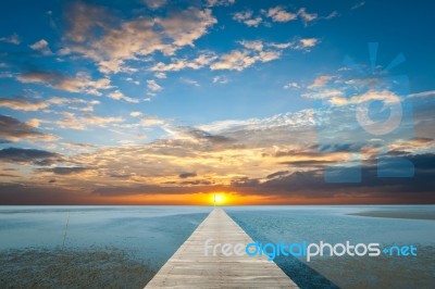 Sunrise Over The Sea With Pier On The Foreground Stock Photo