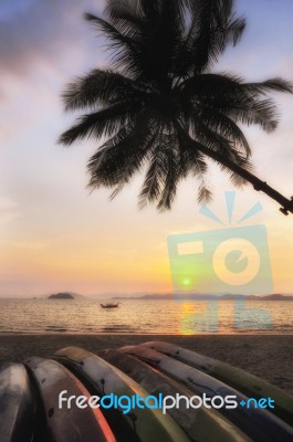 Sunrise With Kayak Boat And Coconut Palm Trees On Tropical Beach… Stock Photo